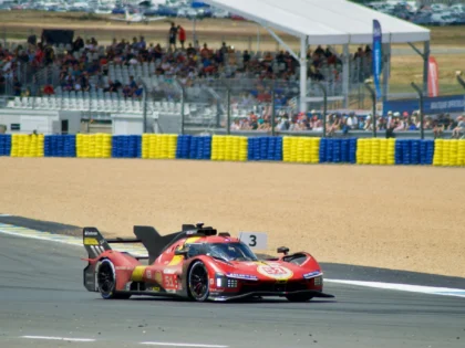 Red Ferrari endurance Hypercar competing at the Circuit de la Sarthe during the 24 Hours of Le Mans.